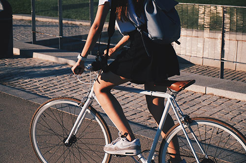 A Girl Riding Her Bicycle In The City